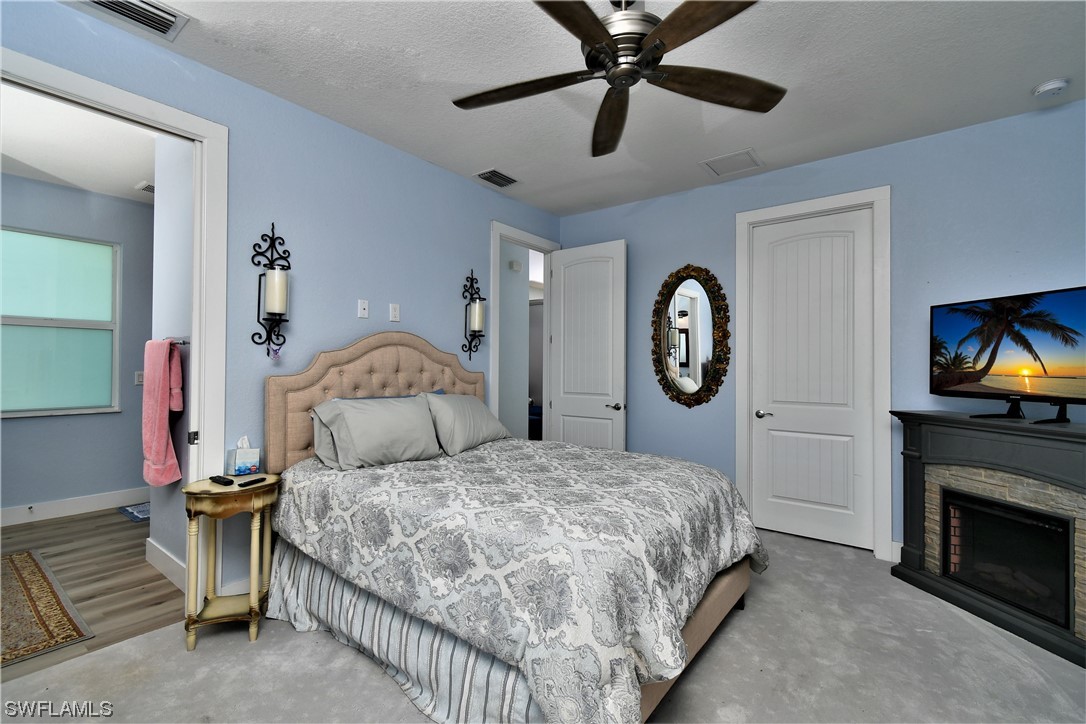 23170 North River Road Alva, FL 33920 - Photo 17 of 50 a bedroom with a bed and a tv on the dresser