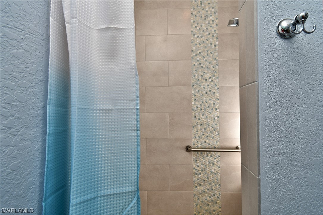23170 North River Road Alva, FL 33920 - Photo 19 of 50 a bathroom with a shower