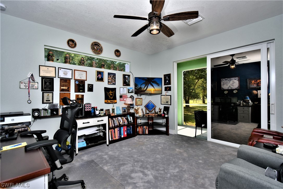 23170 North River Road Alva, FL 33920 - Photo 25 of 50 a view of a livingroom with furniture and a ceiling fan