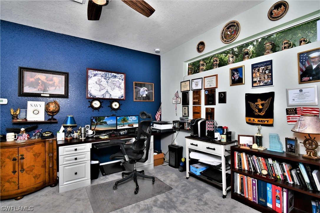 23170 North River Road Alva, FL 33920 - Photo 26 of 50 a work room with furniture and a flat screen tv