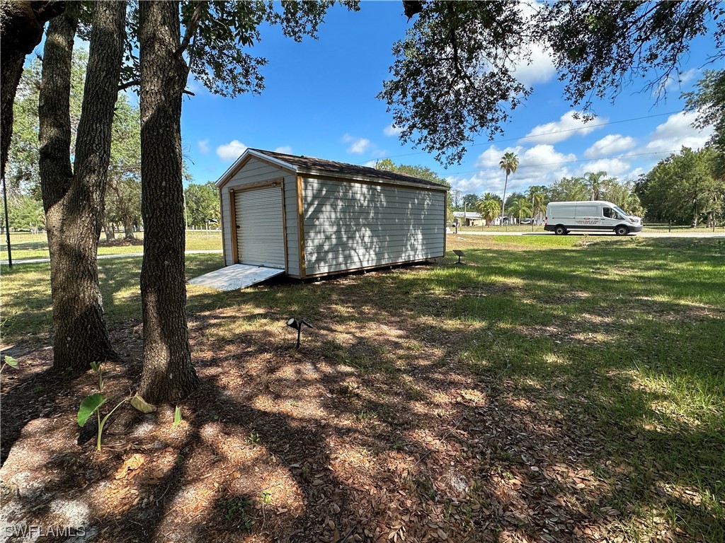 23170 North River Road Alva, FL 33920 - Photo 34 of 50 a view of a tree in front of a house with a big yard
