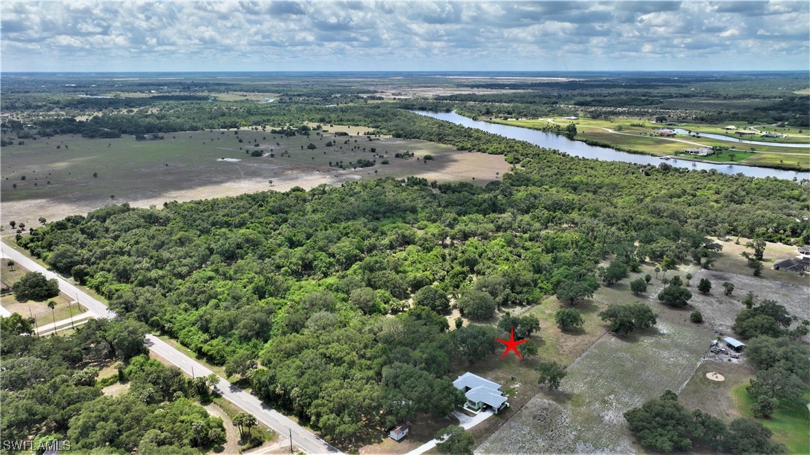 23170 North River Road Alva, FL 33920 - Photo 44 of 50 an aerial view of a house with a yard and lake view