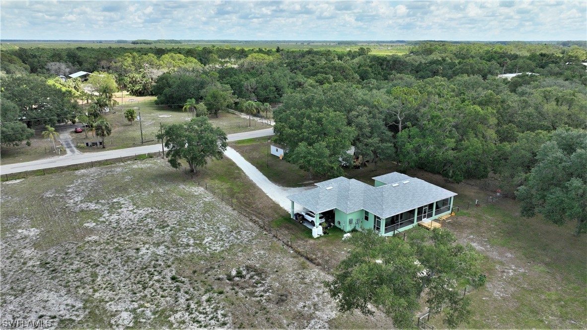23170 North River Road Alva, FL 33920 - Photo 46 of 50 a view of a backyard with plants and outdoor seating