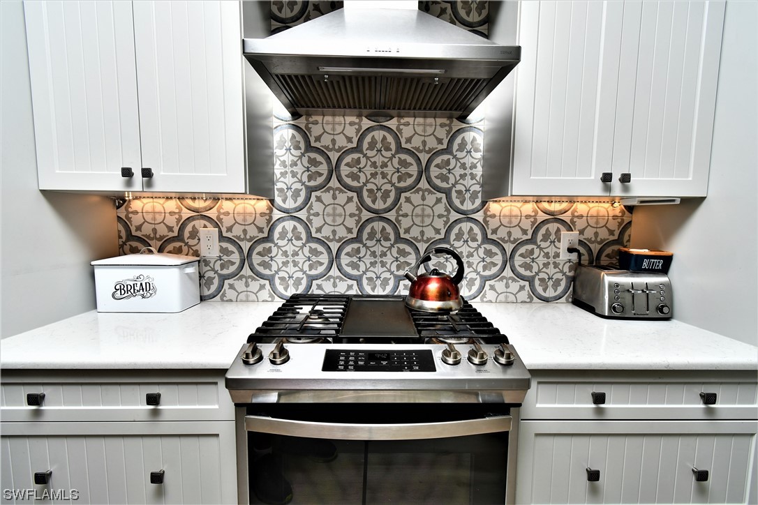 23170 North River Road Alva, FL 33920 - Photo 9 of 50 a stove top oven sitting inside of a kitchen