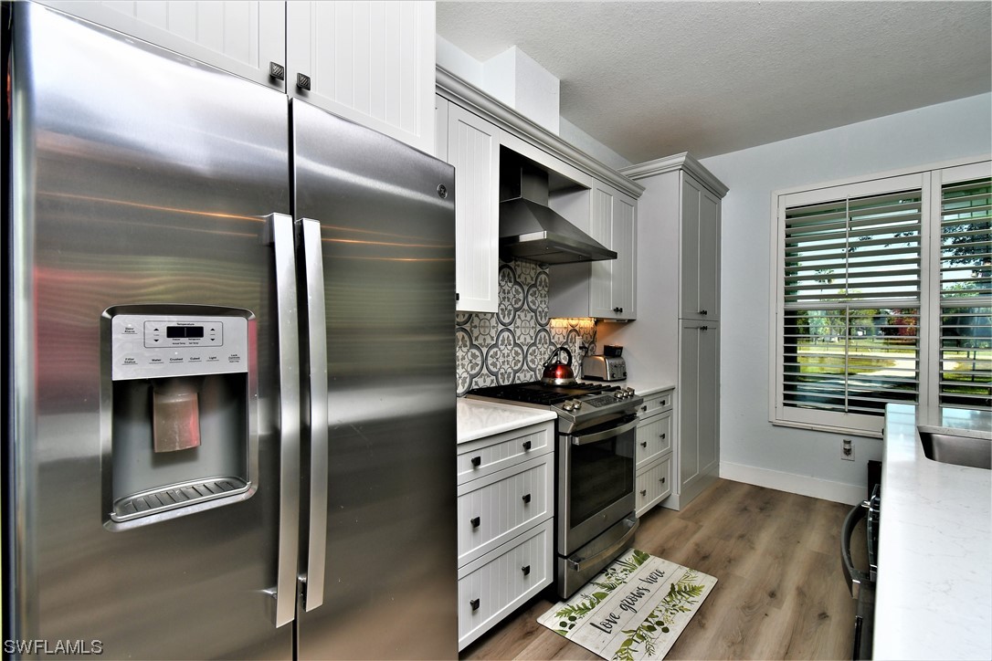 23170 North River Road Alva, FL 33920 - Photo 10 of 50 a kitchen with stainless steel appliances a refrigerator a stove and a window