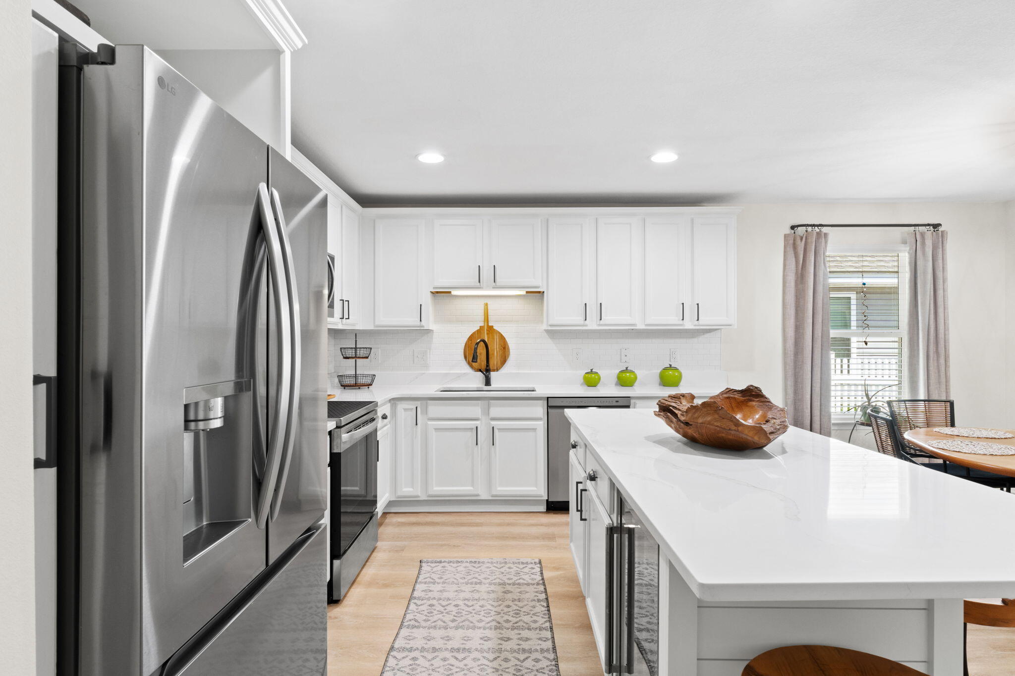 587 Fanny Ann Way Freeport, FL 32439 - Photo 5 of 78 a kitchen with a sink a refrigerator and white cabinets