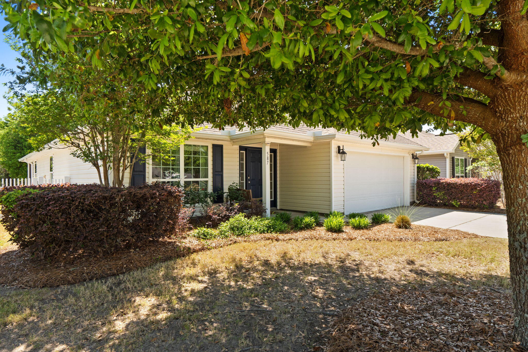 587 Fanny Ann Way Freeport, FL 32439 - Photo 57 of 78 a front view of a house with a yard and garage