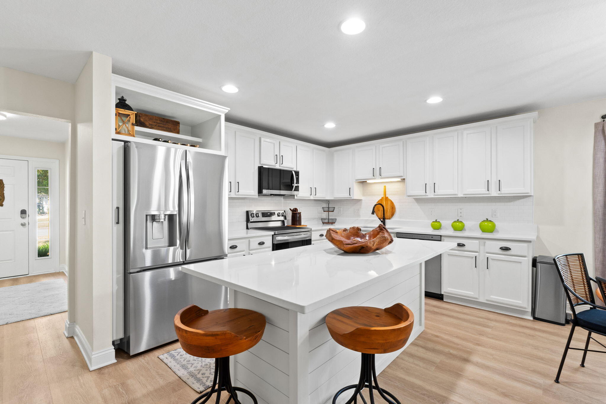 587 Fanny Ann Way Freeport, FL 32439 - Photo 6 of 78 a kitchen with stainless steel appliances granite countertop a refrigerator and a stove top oven with white countertops