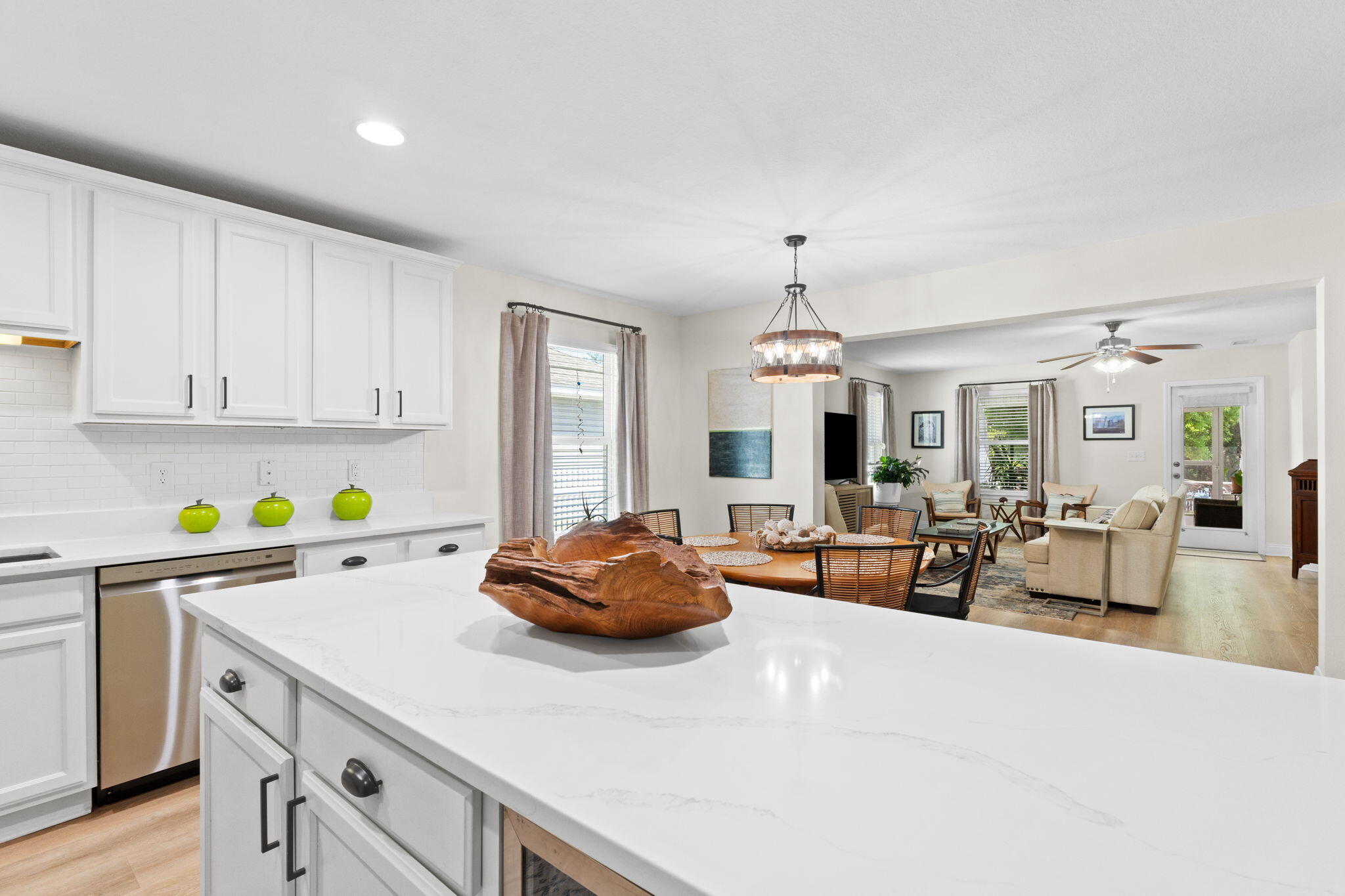587 Fanny Ann Way Freeport, FL 32439 - Photo 8 of 78 a kitchen with stainless steel appliances a white table chairs and a refrigerator