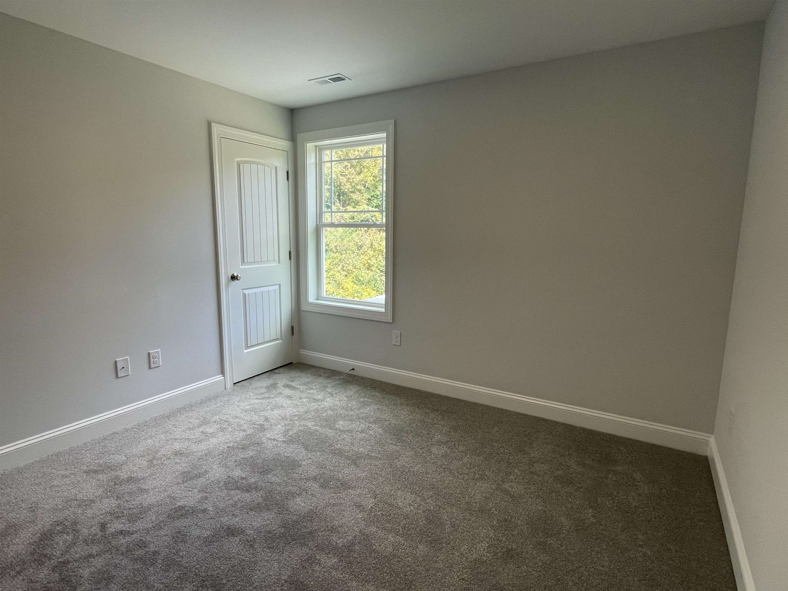 175 Devilwood Drive Four Oaks, NC 27524 - Photo 15 of 20 an empty room with windows