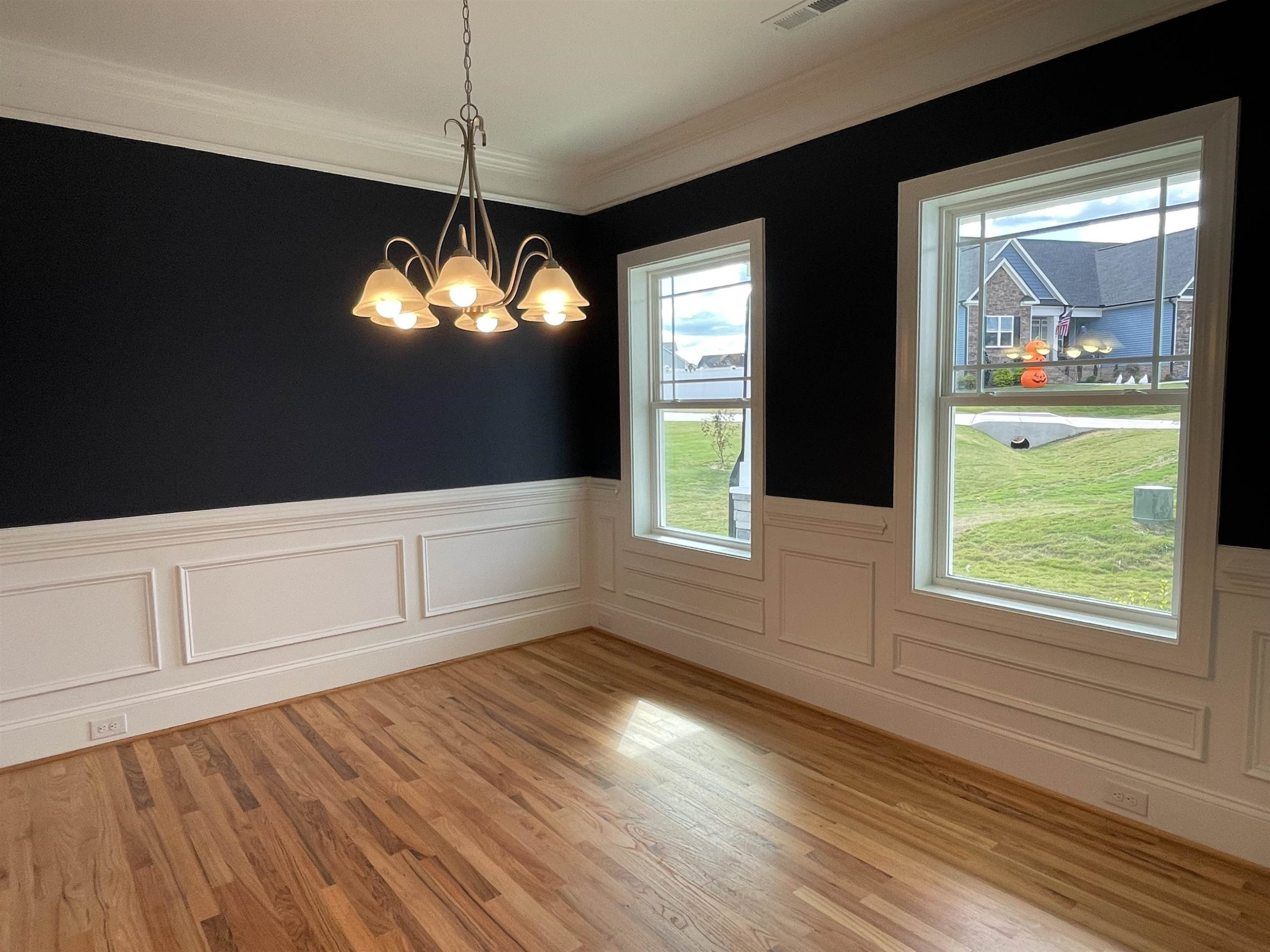 175 Devilwood Drive Four Oaks, NC 27524 - Photo 2 of 20 a view of an empty room with wooden floor and a window