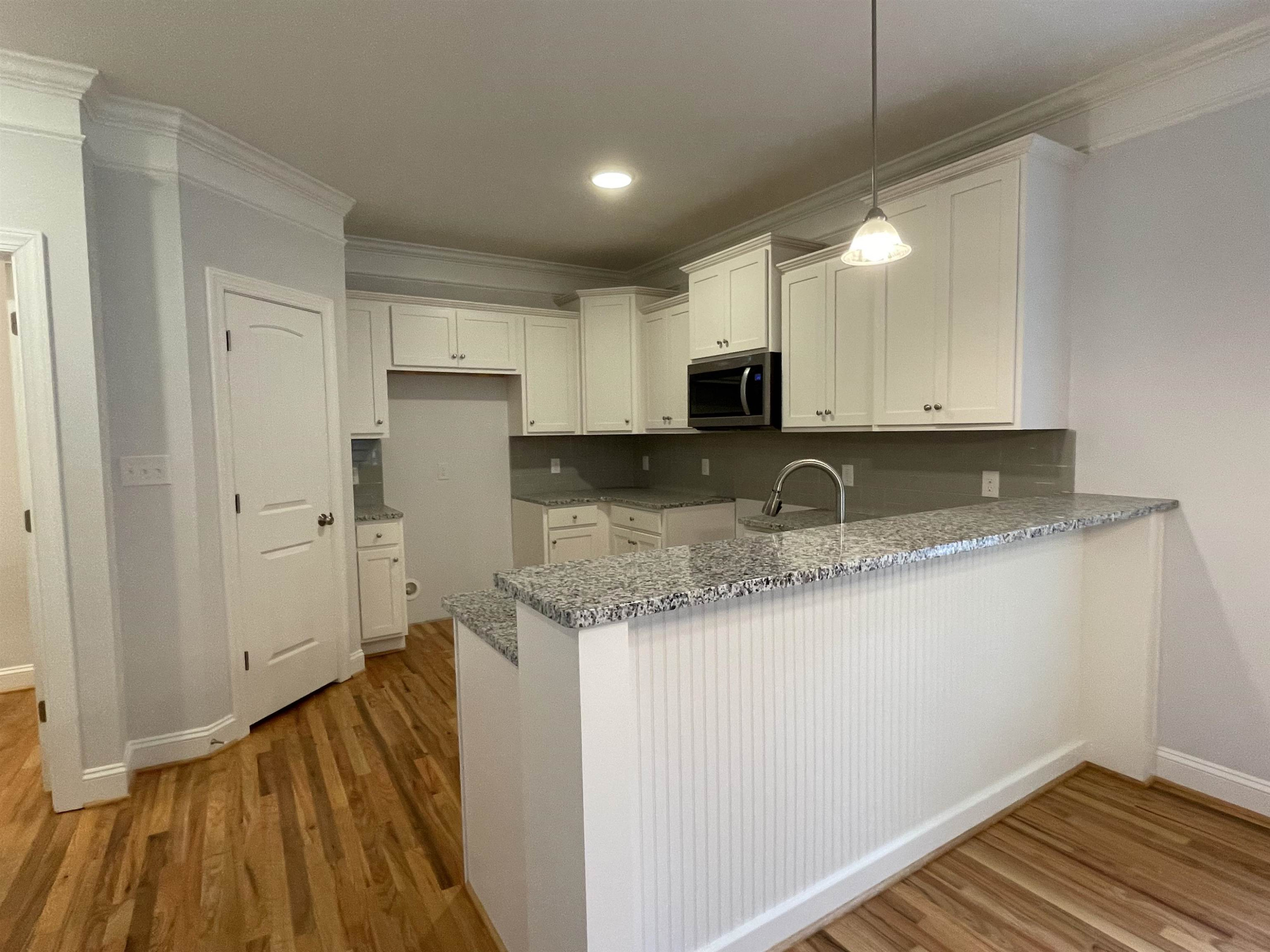 175 Devilwood Drive Four Oaks, NC 27524 - Photo 4 of 20 a kitchen with sink a microwave and cabinets