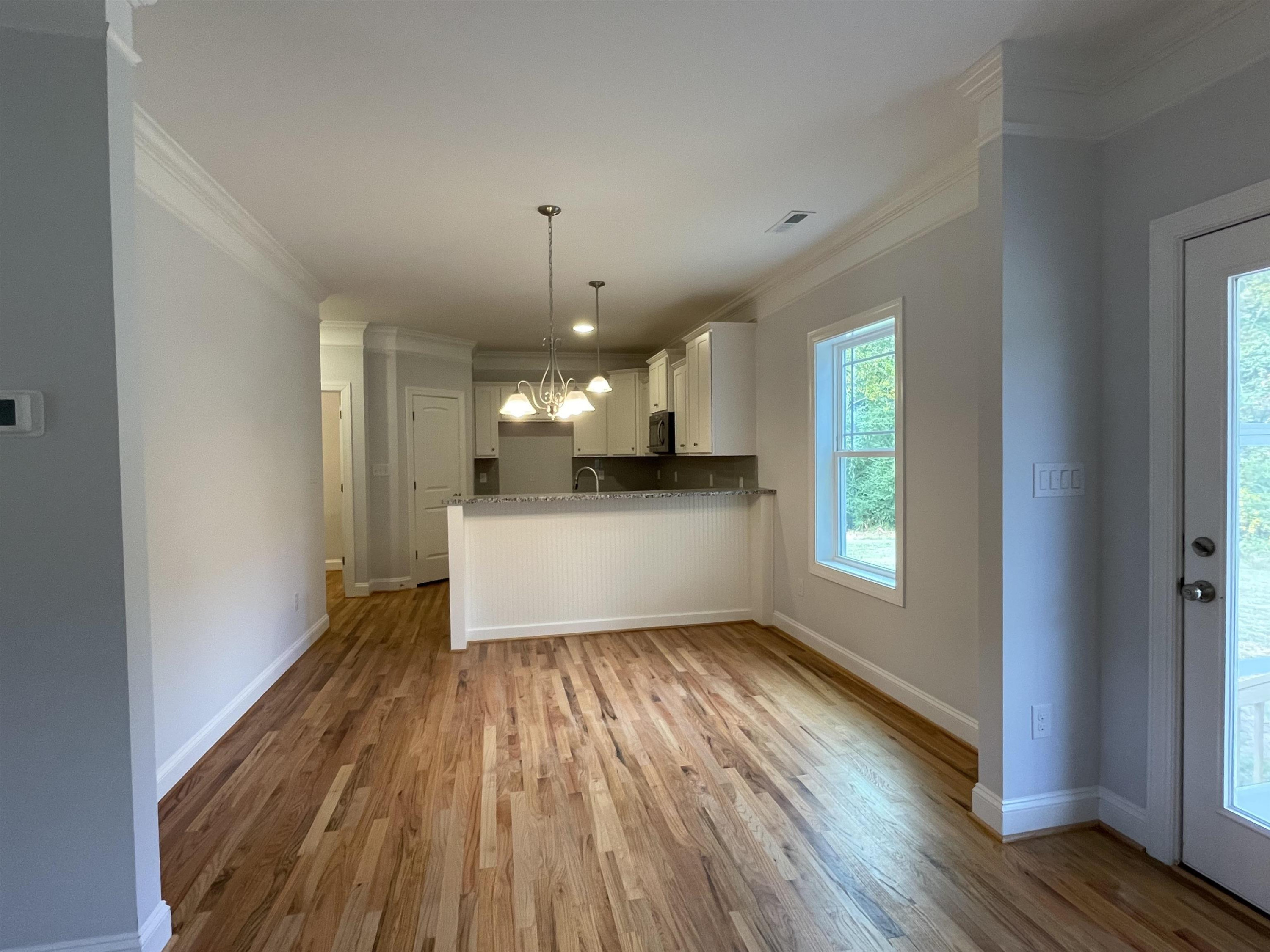 175 Devilwood Drive Four Oaks, NC 27524 - Photo 5 of 20 a view of a kitchen with a sink and dishwasher a refrigerator with wooden floor