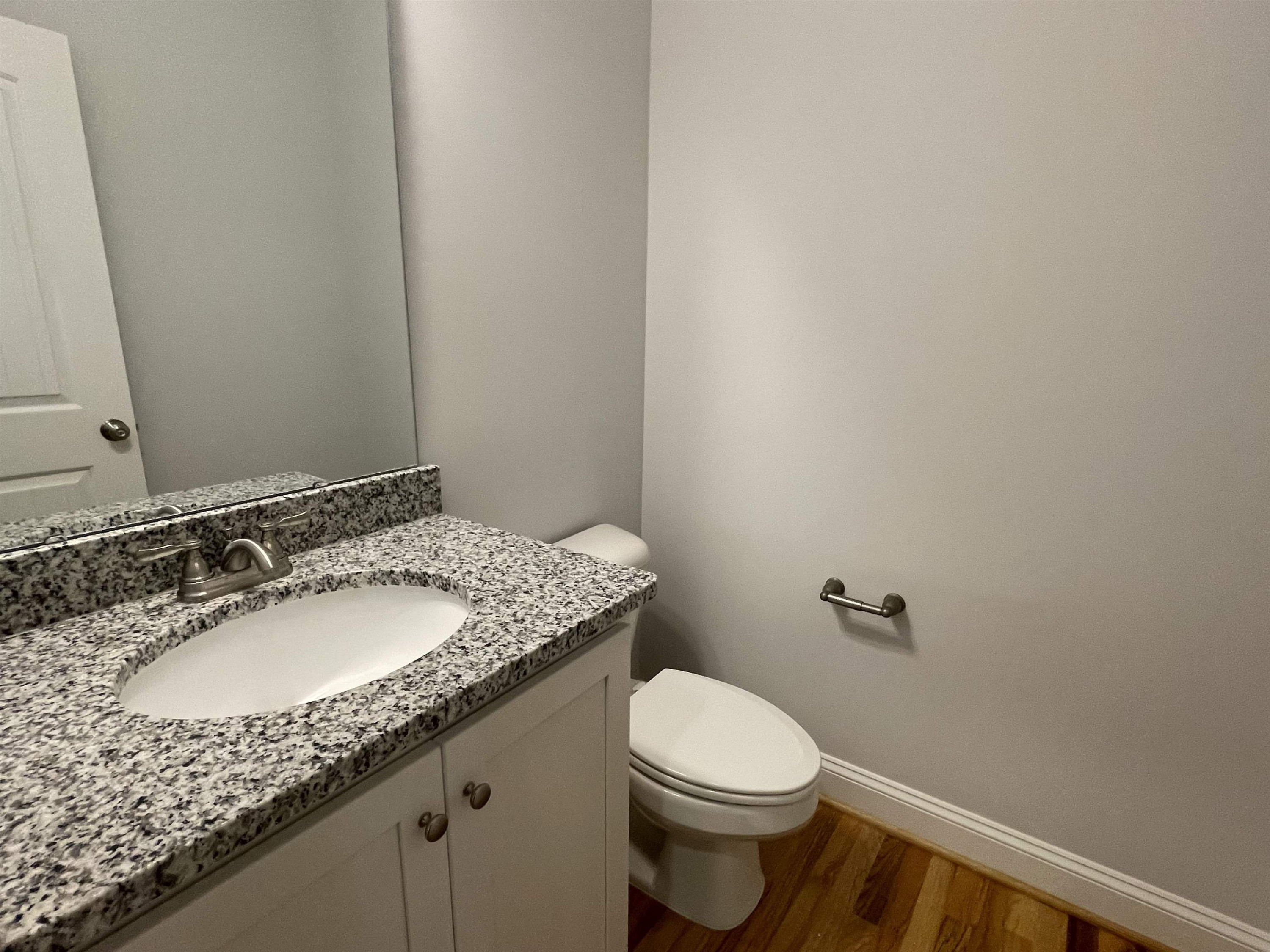 175 Devilwood Drive Four Oaks, NC 27524 - Photo 6 of 20 a bathroom with a granite countertop sink and a mirror