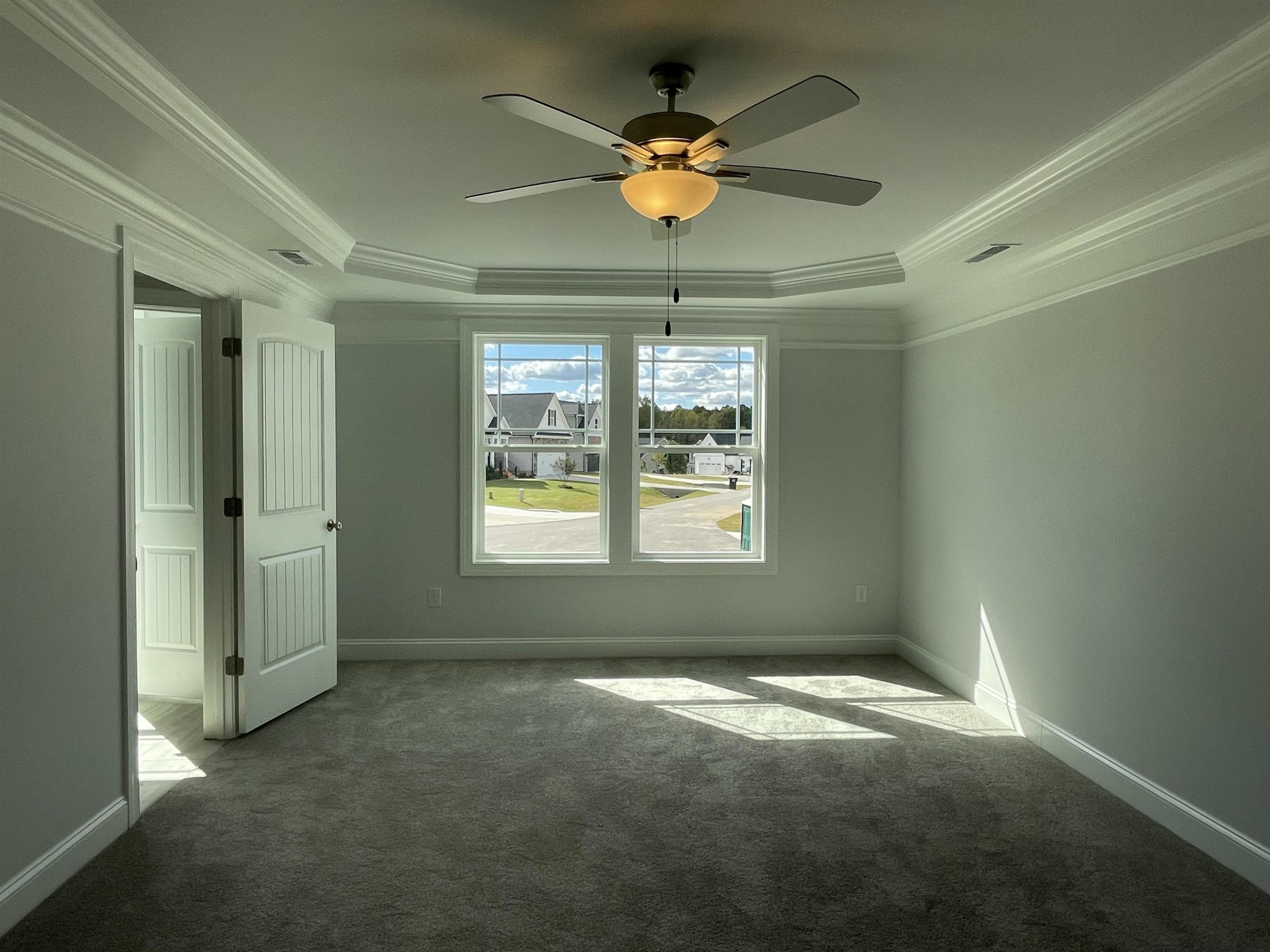 175 Devilwood Drive Four Oaks, NC 27524 - Photo 8 of 20 an empty room with windows and fan