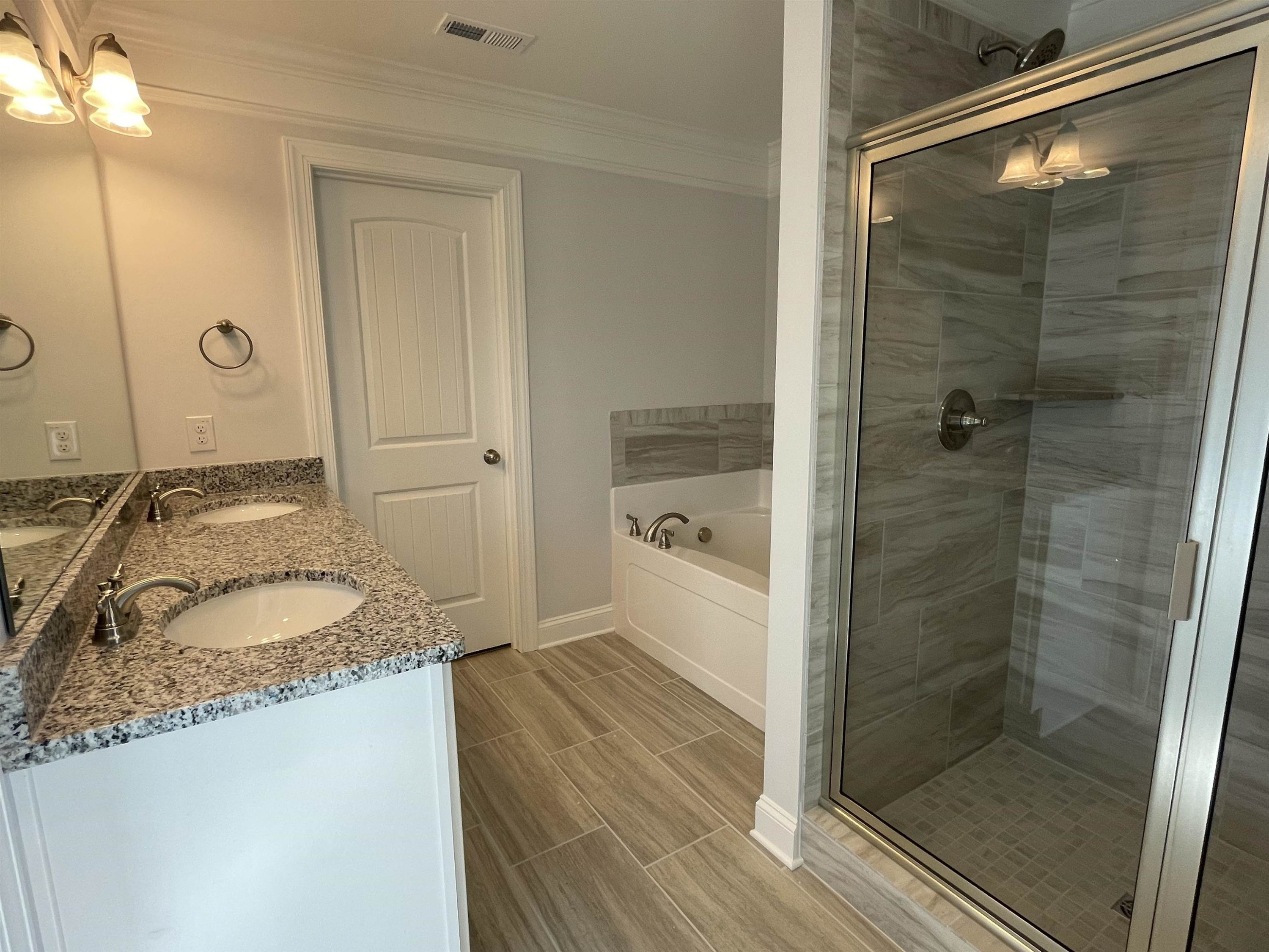 175 Devilwood Drive Four Oaks, NC 27524 - Photo 10 of 20 a bathroom with a granite countertop sink a mirror and shower