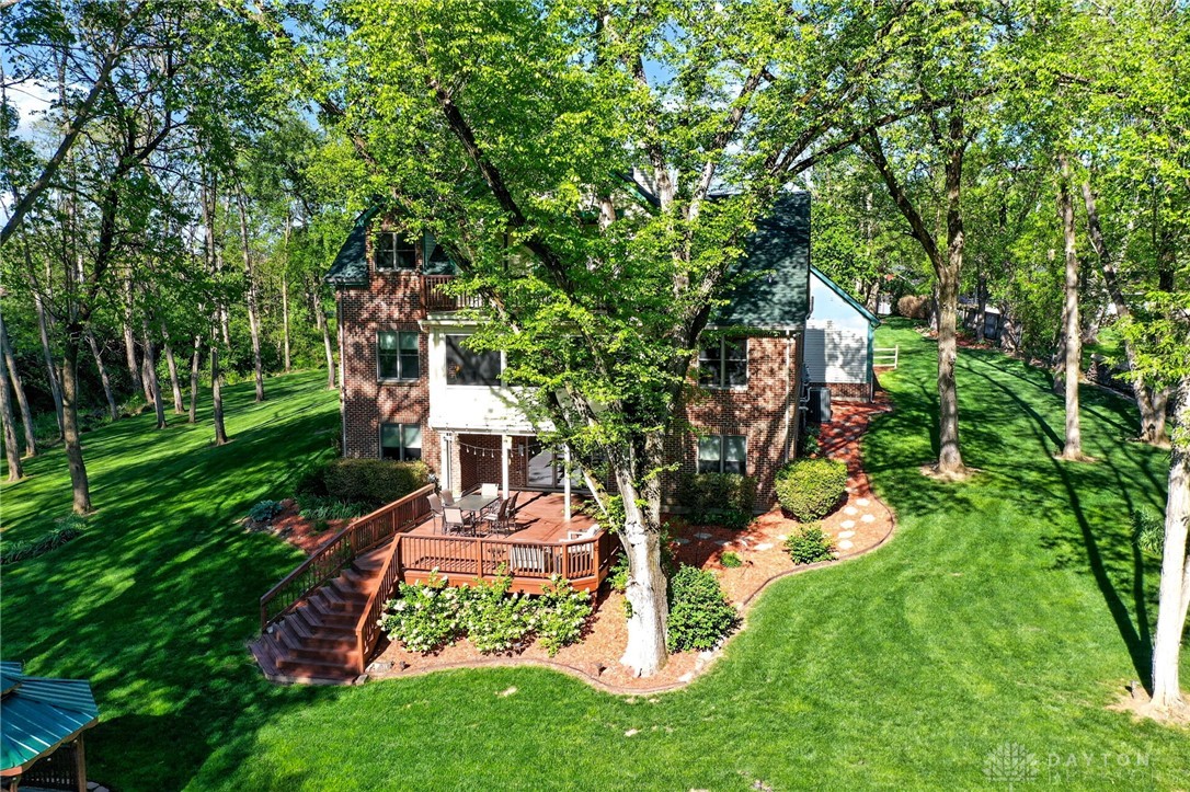 330 South Alpha Bellbrook Road Bellbrook, OH 45305 - Photo 75 of 87 This home is nestled among a lush, treed landscape, featuring a large deck for outdoor enjoyment.