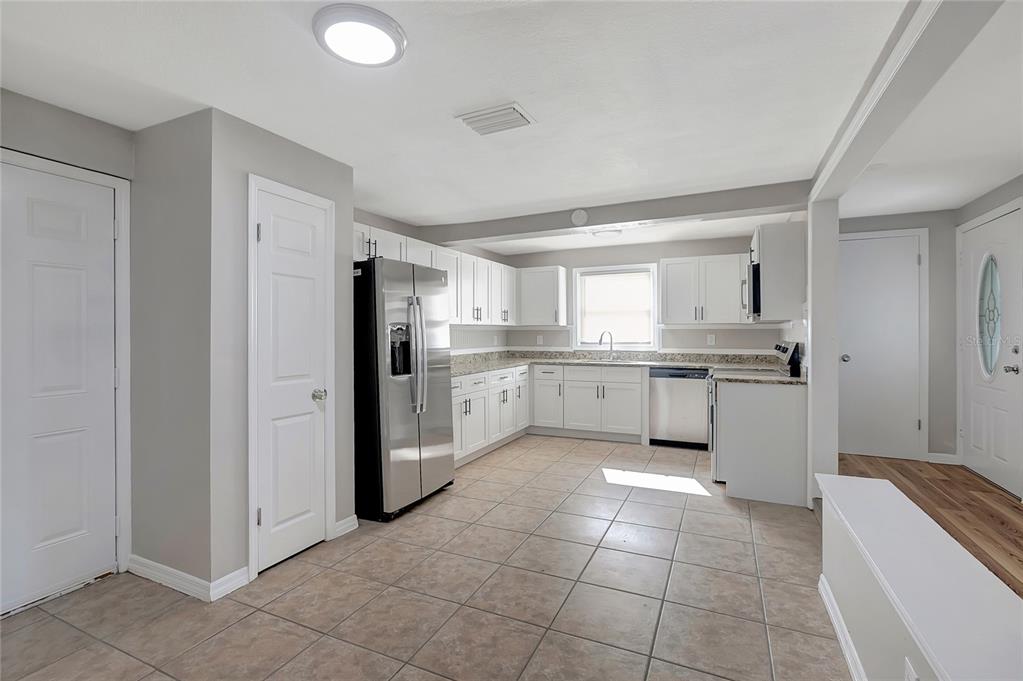 5605 Oceanic Road Holiday, FL 34690 - Photo 11 of 36 a kitchen with a stove a sink and a refrigerator