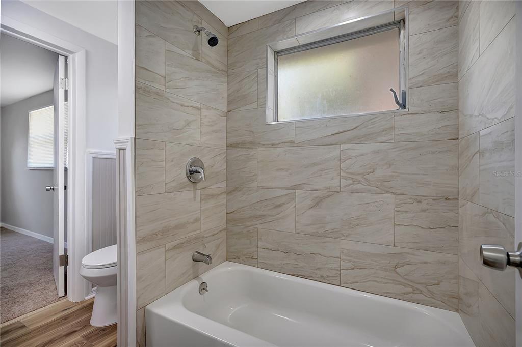 5605 Oceanic Road Holiday, FL 34690 - Photo 24 of 36 a bathroom with a bathtub and toilet