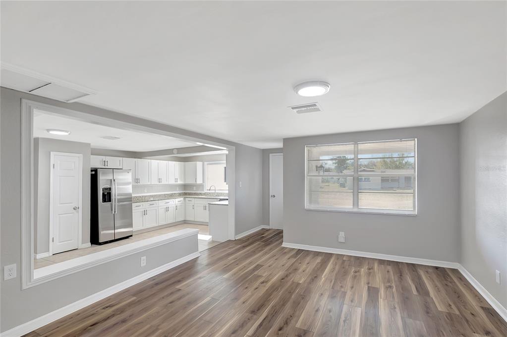 5605 Oceanic Road Holiday, FL 34690 - Photo 5 of 36 an empty room with wooden floor and window