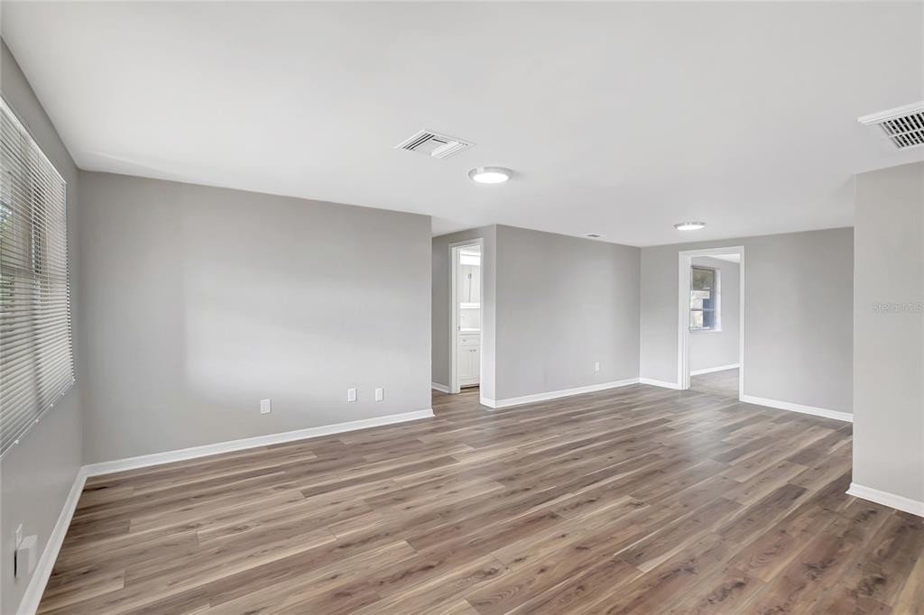5605 Oceanic Road Holiday, FL 34690 - Photo 8 of 36 a view of an empty room with wooden floor and a window