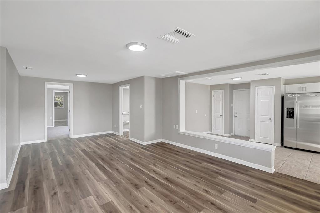 5605 Oceanic Road Holiday, FL 34690 - Photo 9 of 36 a view of empty room with wooden floor and fan