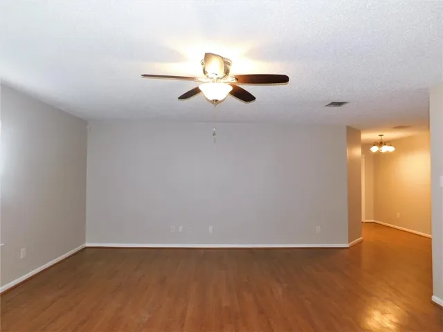 a view of a room with wooden floor