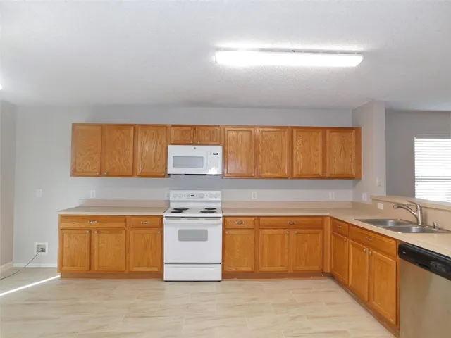 a kitchen with a sink cabinets and window