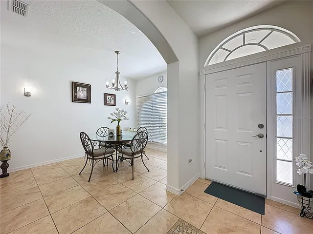 a view of a dining room with furniture and a window