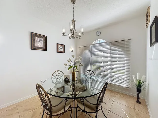 a view of a dining room with furniture and chandelier