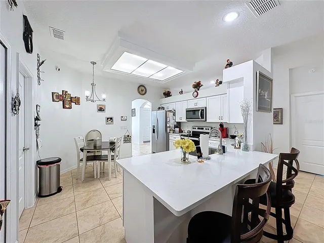 a kitchen with stainless steel appliances kitchen island granite countertop a sink and cabinets