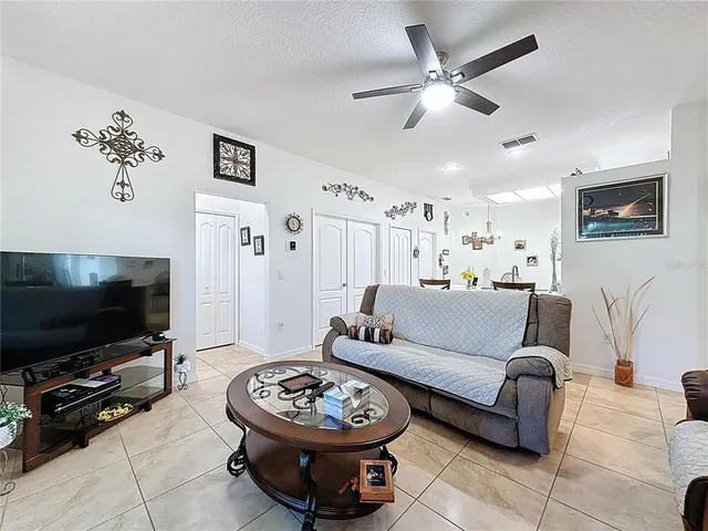 a living room with furniture and a view of kitchen