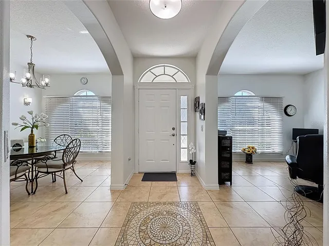 a view of a livingroom with workspace and a window
