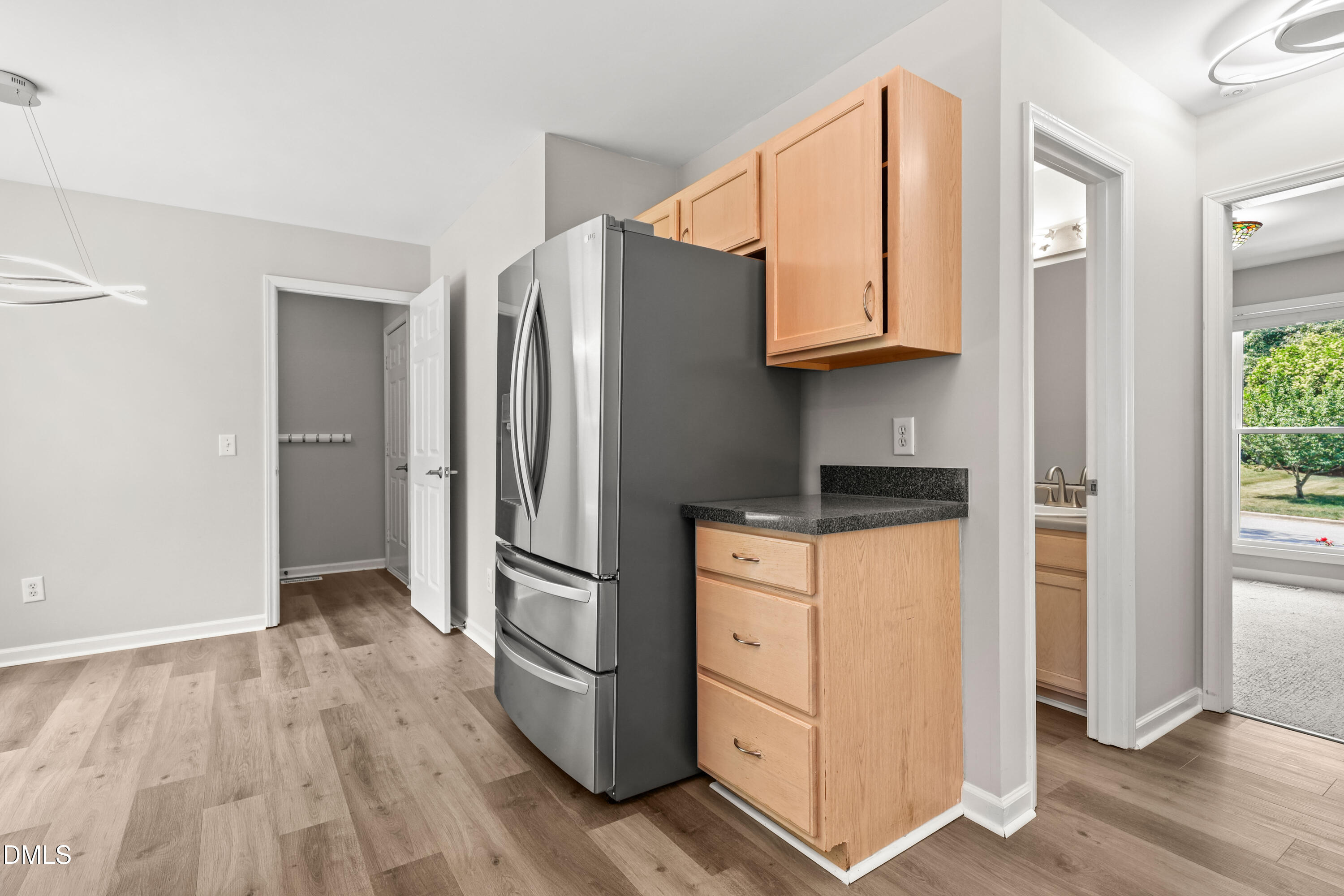 3015 Rennit Court Raleigh, NC 27603 - Photo 13 of 40 a kitchen with white cabinets and refrigerator