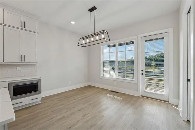 a view of wooden floor wooden cabinets and a fireplace