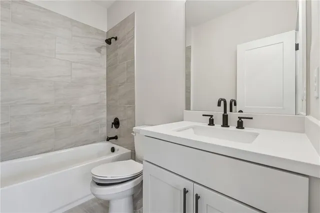 a bathroom with a sink a toilet and a bathtub