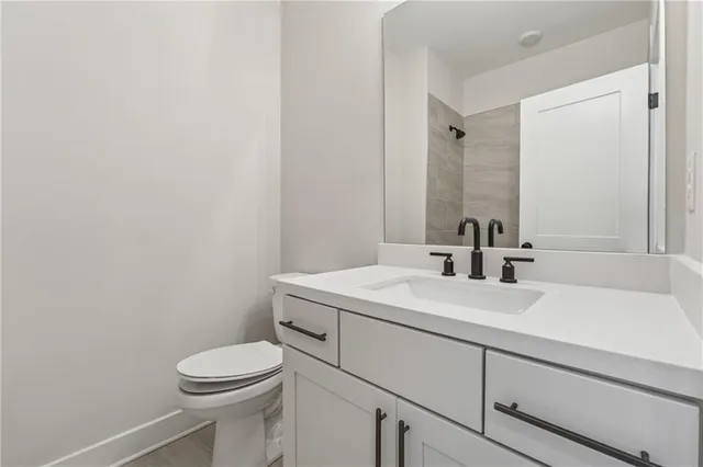 a bathroom with a sink a toilet and mirror