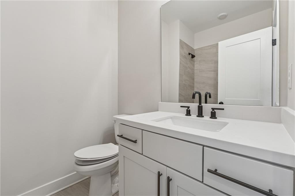 428 Mezzo Lane Alpharetta, GA 30009 - Photo 22 of 30 a bathroom with a sink a toilet and mirror