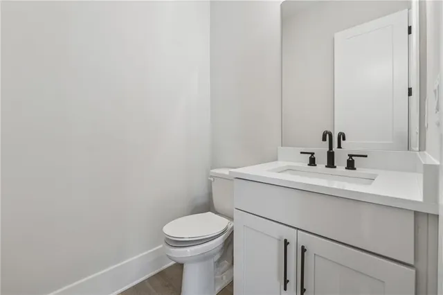 a bathroom with a sink toilet and mirror