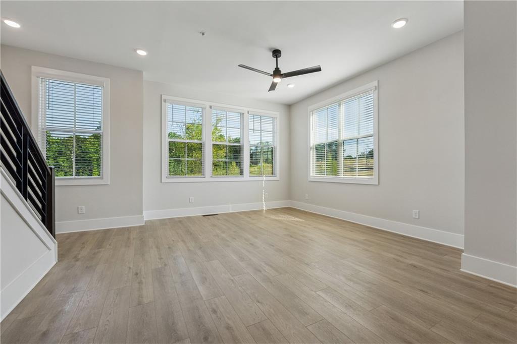428 Mezzo Lane Alpharetta, GA 30009 - Photo 4 of 30 a view of an empty room with a window and wooden floor
