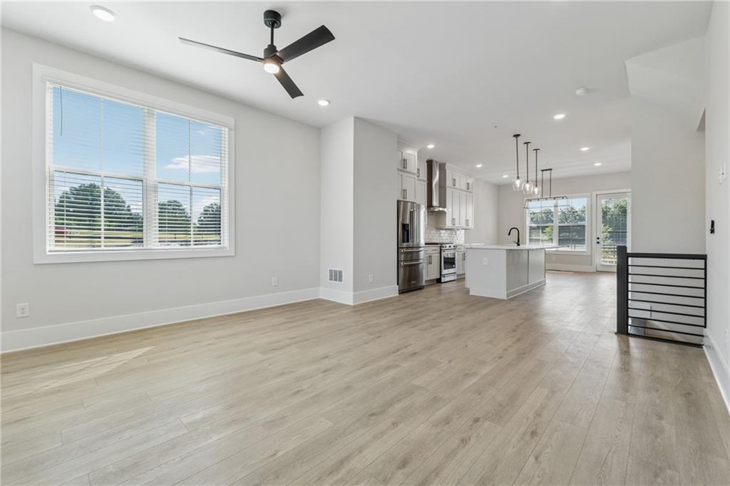 428 Mezzo Lane Alpharetta, GA 30009 - Photo 5 of 30 a view of an empty room with wooden floor and a window