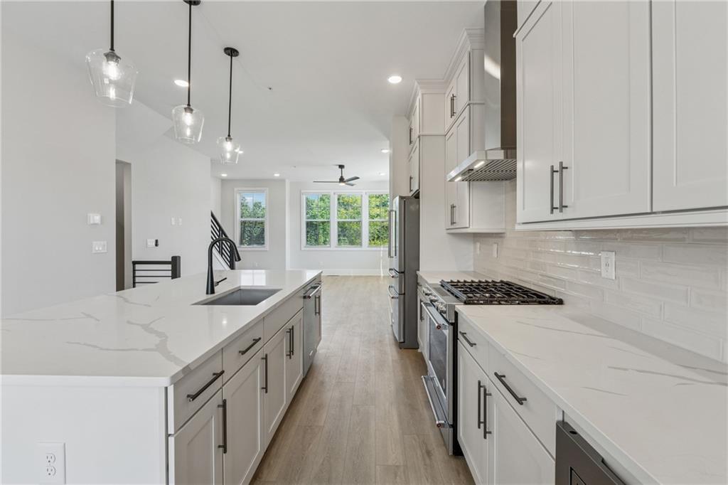 428 Mezzo Lane Alpharetta, GA 30009 - Photo 8 of 30 a kitchen with stainless steel appliances granite countertop a sink a stove and a wooden floors