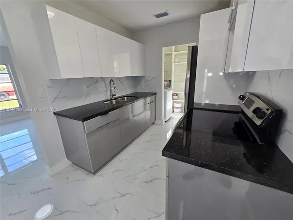 a kitchen with a sink and cabinets