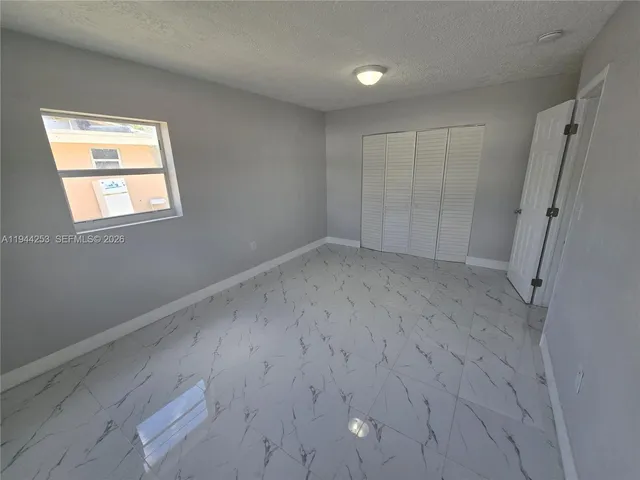 a view of an empty room with windows