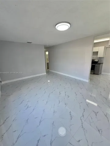 a kitchen with granite countertop a stove and cabinets