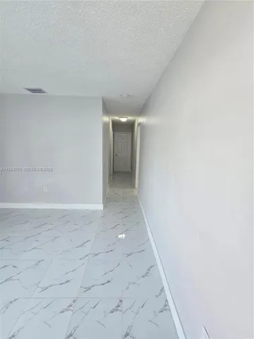 a close view of sink a microwave and refrigerator in the kitchen