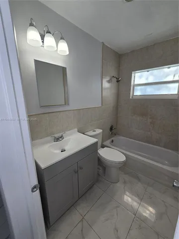 a stove top oven sitting inside of a kitchen