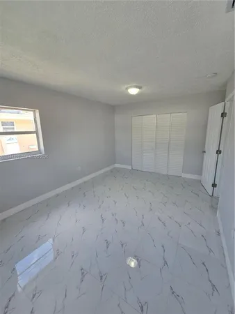a kitchen with granite countertop a sink a stove and a granite counter top