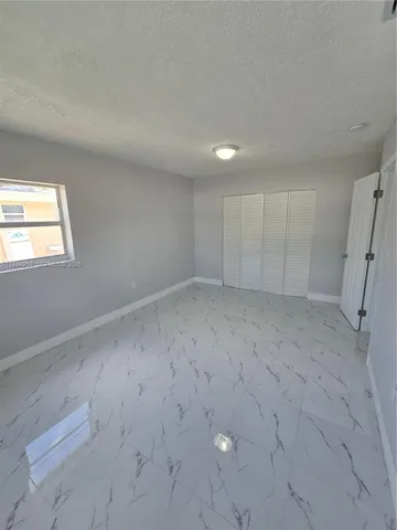 a kitchen with granite countertop a sink a stove and a granite counter top