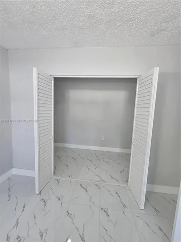 a kitchen with granite countertop a sink and a stove top oven